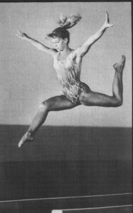 Jenny Smith, teen-age gymnast performing a leap