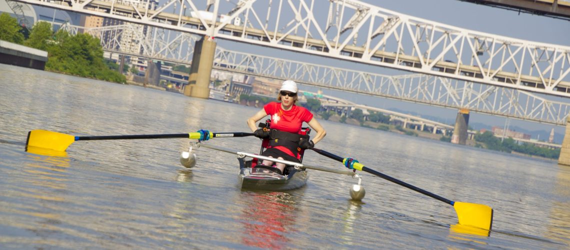 Jenny Smith rowing a racing scull on a large river